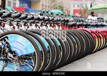 --FILE--Rental bicycles are lined up at a rental site in Beijing, China, 13 September 2008.   Beijing authorities aim to increase the proportion of cy Stock Photo