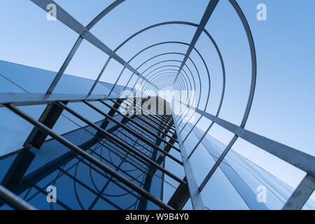Fire escape staircase of modern business center. Stairway to Heaven concept. Emergency fire exit. Bottom view Stock Photo