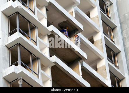 --FILE--Chinese workers are constructing a residential apartment building under construction in Nanjing city, east Chinas Jiangsu province, 31 October Stock Photo