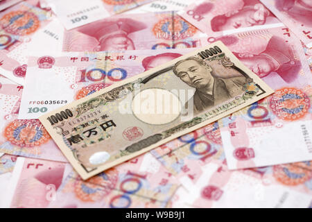 Japanese yen banknote and chinese yuan currency for trade and economic  concept, tax, stock market of asia Stock Photo - Alamy