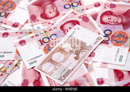 --FILE--Photo taken in Shanghai, China on 12 November 2009 shows Euro and RMB (renminbi) yuan banknotes.   Treasury Secretary Timothy Geithner and Ita Stock Photo
