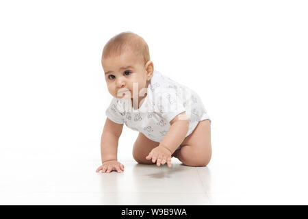 Baby boy crawling on floor Stock Photo