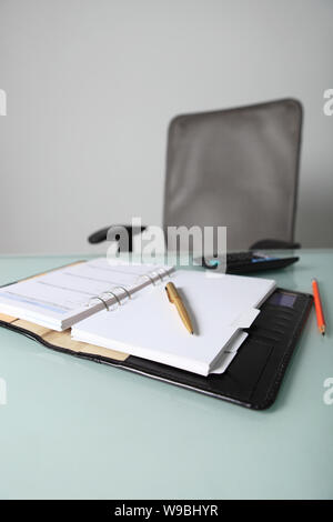 Personal organizer and calculator on a desk Stock Photo
