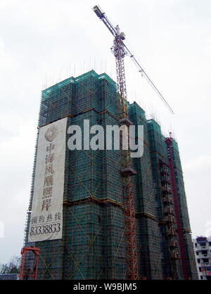 An apartment building is under construction in Nanjing, east Chinas Jiangsu province, June 27, 2010.   China will widen the field of permitted investm Stock Photo