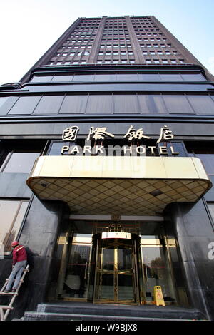 A Chinese worker puts final touches on the Park Hotel after a face-lift in Shanghai, China, 6 January 2010.   The Park Hotel, the highest building in Stock Photo