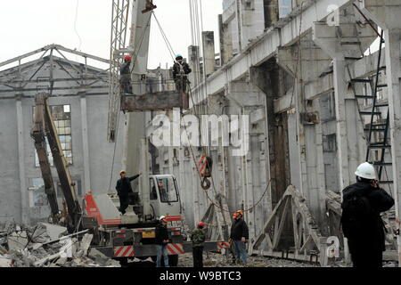 --FILE--Chinese construction workers demolish old buildings to construct new facilities for the World Expo 2010 in Shanghai, China, 6 March 2009.   Th Stock Photo