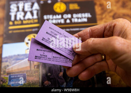 UK, England, Devon, Buckfastleigh, South Devon Railway, hand holding two return rail tickets to Totnes Stock Photo