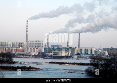 --FILE--Smoke is seen being emitted from chimneys at plants at the bank of Songhua River in Jilin city, northeast Chinas Jilin province, 19 November 2 Stock Photo