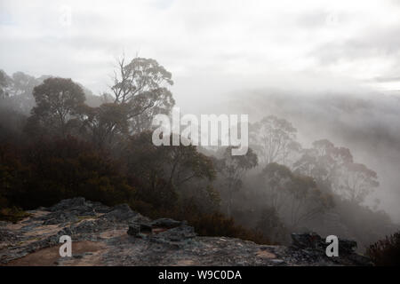 The view of surrounding mountains and fog in the valleys looking from Hassans Walls Lithgow new South Wales Australia on 31st July 2019 Stock Photo