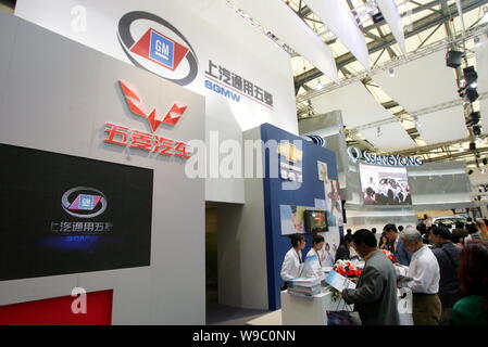 --FILE--Chinese visitors are seen at the stand of SGMW (SAIC-GM-Wuling) with the logos of Shanghai GM, Wuling and Chevrolet at the 12th Shanghai Inter Stock Photo