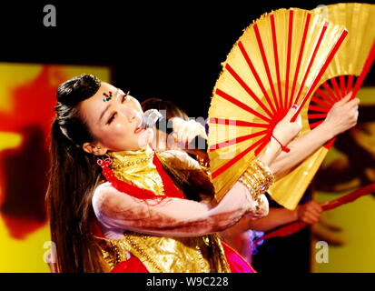 Chinese singer Sa Dingding performs during an event marking the third anniversary of Mercedes-Benz Green Legacy Program, in Lushan Moutain, Jiujiang, Stock Photo