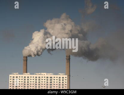 --FILE--Smoke is seen being emitted from chimneys at a chemical plant in Jilin city, northeast Chinas Jilin province, 13 December 2008.   The cost of Stock Photo