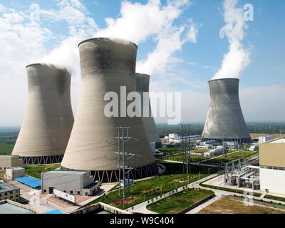 --FILE--Smoke is seen emitted from cooling towers of a heat power plant in Zoucheng city, east Chinas Shandong province, 8 September 2008.   China wil Stock Photo