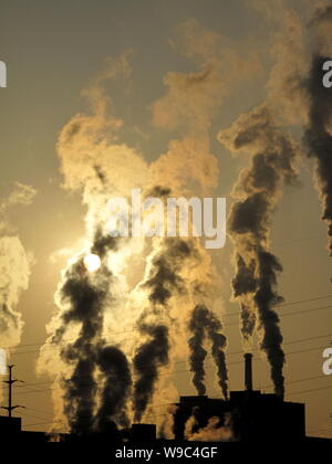 --FILE--Smoke is seen being emitted from chimneys at a paper plant in Jilin city, northeast Chinas Jilin province, 29 November 2009.   Chinese officia Stock Photo