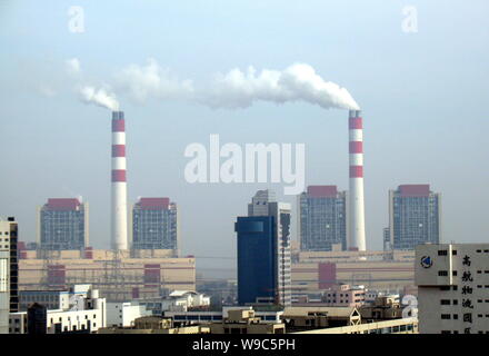 --FILE--Smoke is seen emitted from chimneys of a heat power plant in Shanghai, China, 3 December 2008.   China will include a pilot emissions trading Stock Photo