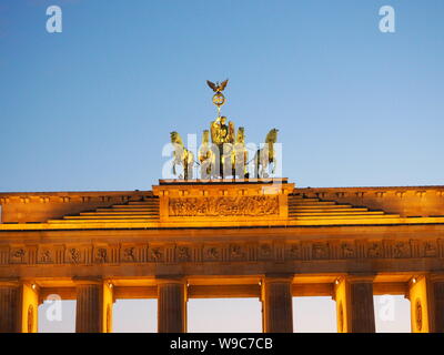 Germany, Berlin, The Brandenburg Gate The Quadriga on top of the gate featuring a chariot drawn by four horses driven by Victoria the Roman goddess of Stock Photo