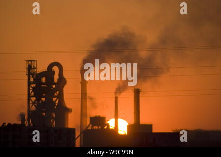 --FILE--Smoke is seen being emitted from chimneys at a cement plant in Jilin city, northeast Chinas Jilin province, 1 March 2009.   The cost of reduci Stock Photo