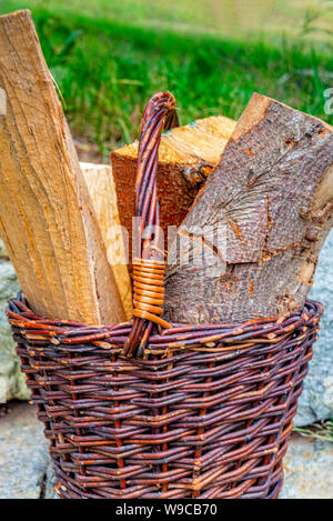 Various wooden logs in a wicker basket Stock Photo