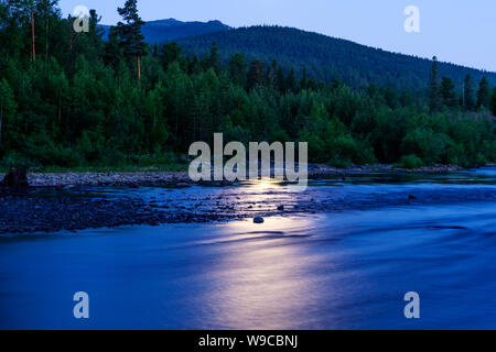 Night landscape - a reflection of the moon in the river among the forest in the Ural mountains Stock Photo