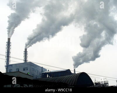 --FILE--Smoke is seen being emitted from chimneys at a chemical plant in Yichang city, central Chinas Hubei province, 25 October 2008.   The cost of r Stock Photo