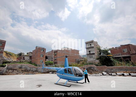 The newly-purchased Robinson R44 Raven II helicopter of Chinese peasant entrepreneur Chen Minggang is seen on a parking apron in Liming village, Cheng Stock Photo