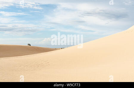 Mui Ne, Vietnam - June 2019: off-road car riding in Bau Trang white sand dunes. Stock Photo