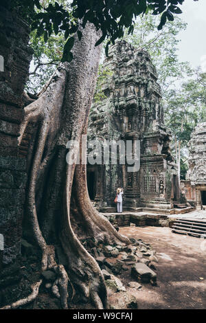 Woman discovering the ruins of Angkor Wat temple complex in Siem Reap, Cambodia. Stock Photo
