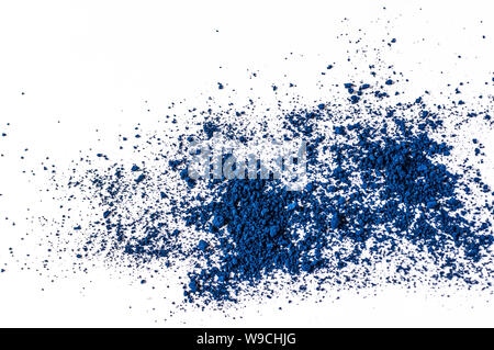Natural dark blue colored matt pigment. Loose cosmetic powder. Eyeshadow pigment isolated on a white background, close-up. Stock Photo