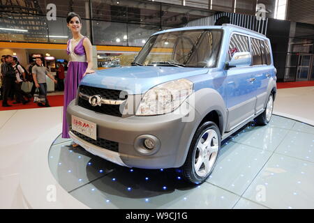 A model poses with a Great Wall Hover M3 at the 13th Shanghai International Automobile Industry Exhibition, known as Auto Shanghai 2009, in Shanghai, Stock Photo