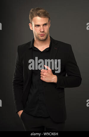 Elegance in simplicity. Black fashion trend. Man elegant manager wear black formal outfit on dark background. Reasons black is the only color worth wearing. Rules for wearing all black clothing. Stock Photo