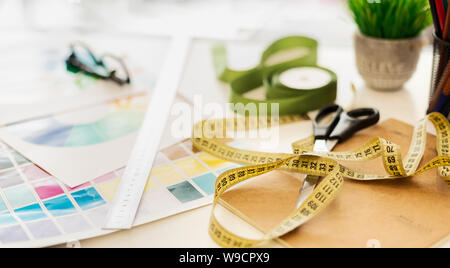 Closeup Of Fashion Designer Workplace With Measuring Tape And Color Samples Stock Photo