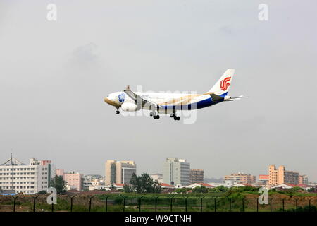 --FILE--A jet plane of Air China is seen landing at the Hongqiao International Airport in Shanghai, China, 1 September 2009.   Shanghai airport author Stock Photo