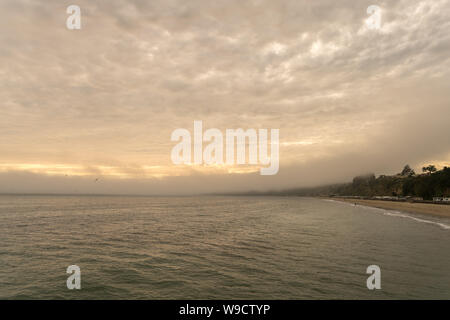 View of Dense Clouds Over West Coast Beach Stock Photo