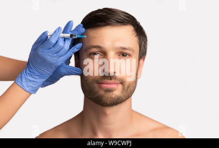 Handsome Man Receiving Hyaluronic Acid Injection, Isolated On White Stock Photo