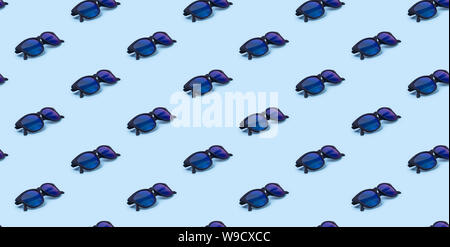 Seamless pattern with trendy modern sunglasses on blue background. Stock Photo