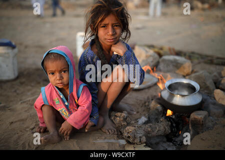 Poor Gypsy children at the Pushkar Camel Fair, Rajasthan. The fair is the largest camel fair in India. Stock Photo