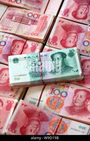 --FILE--Bundles of RMB (renminbi) yuan banknotes are stacked at a ...