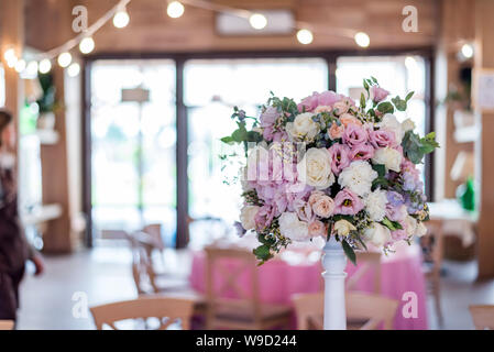 Wedding decor at the banquet. Wedding restaurant decorated with flowers. Luxury wedding table decoration. Special event table set up. Flower decor Stock Photo