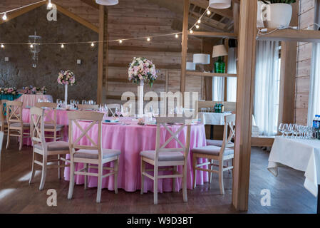 Wedding decor at the banquet. Wedding restaurant decorated with flowers. Luxury wedding table decoration. Special event table set up. Flower decor Stock Photo