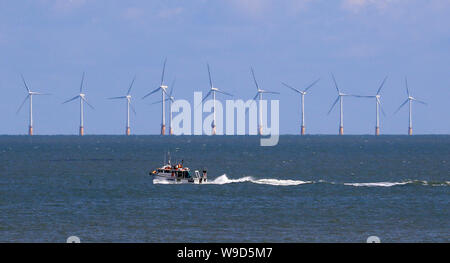 A fishing boat heads out to sea off the coast of Broadstairs, Kent. Stock Photo