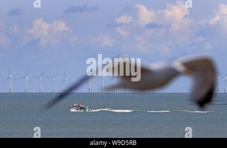 A fishing boat heads out to sea off the coast of Broadstairs, Kent. Stock Photo