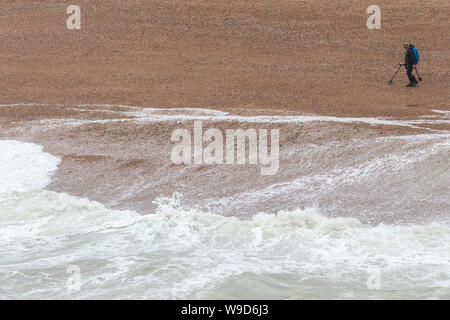 metal detector man on brighton beach Stock Photo