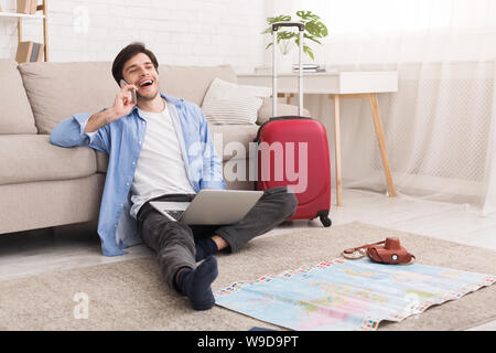 Happy man preparing for vacation, consulting with travel agent Stock Photo