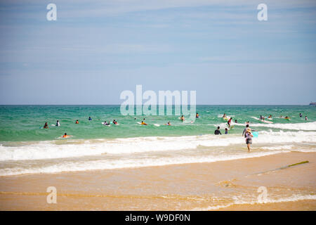 Sanya, Hainan Island, China - 22.06.2019: People on the beach and in the sea in Area for Surfing, Hainan, China Stock Photo