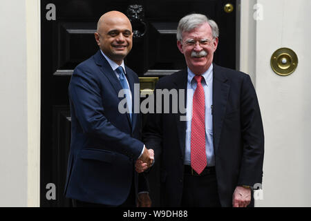 London, Britain. 13th Aug, 2019. Visiting U.S. National Security Adviser John Bolton (R) is greeted by British Chancellor of the Exchequer Sajid Javid at 11 Downing Street in London, Britain, Aug. 13, 2019. Credit: Alberto Pezzali/Xinhua Stock Photo