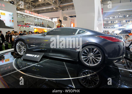 Visitors look at a model posing with a Geely GT concept roadster during the Auto China 2008 car show in Beijing, China, 20 April 2008.   The Auto Chin Stock Photo