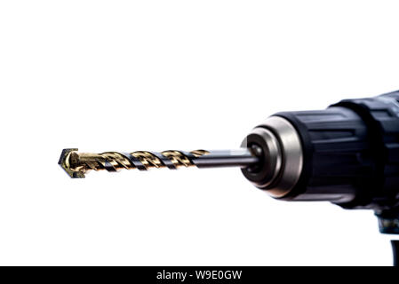 Close up of tungsten carbide tipped drill bit, in the chuck of an electric drill. Stock Photo