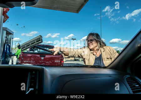 Female cleaning car windshield Stock Photo