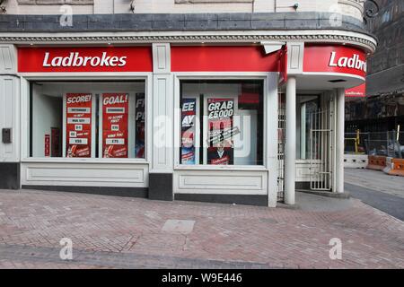 BIRMINGHAM, UK - APRIL 19, 2013: Ladbrokes betting and gaming shop in Birmingham, UK. Ladbrokes has 2,400 retail betting shops in the UK and Ireland. Stock Photo