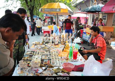 BANGKOK, THAILAND - DECEMBER 22, 2013: People visit the Amulet Market in Bangkok. The popular outdoor marketplace specializes in Buddhist talismans, l Stock Photo